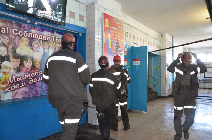 In the mines of ArcelorMittal in Kazakhstan, family is visually present at the workplace. Children on the poster remind miners to work safely as their families are waiting for them (photograph by Eeva Kesküla).