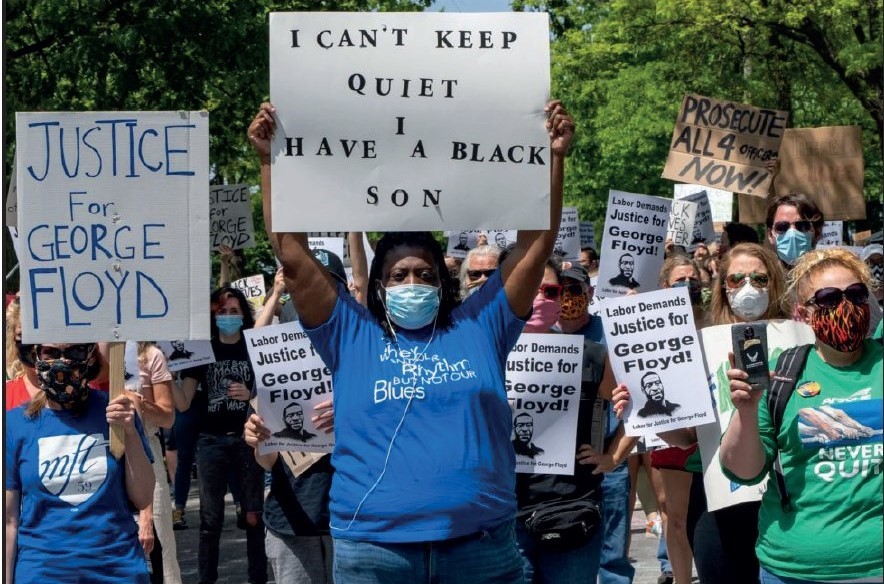 A group of people holding a sign

Description automatically generated