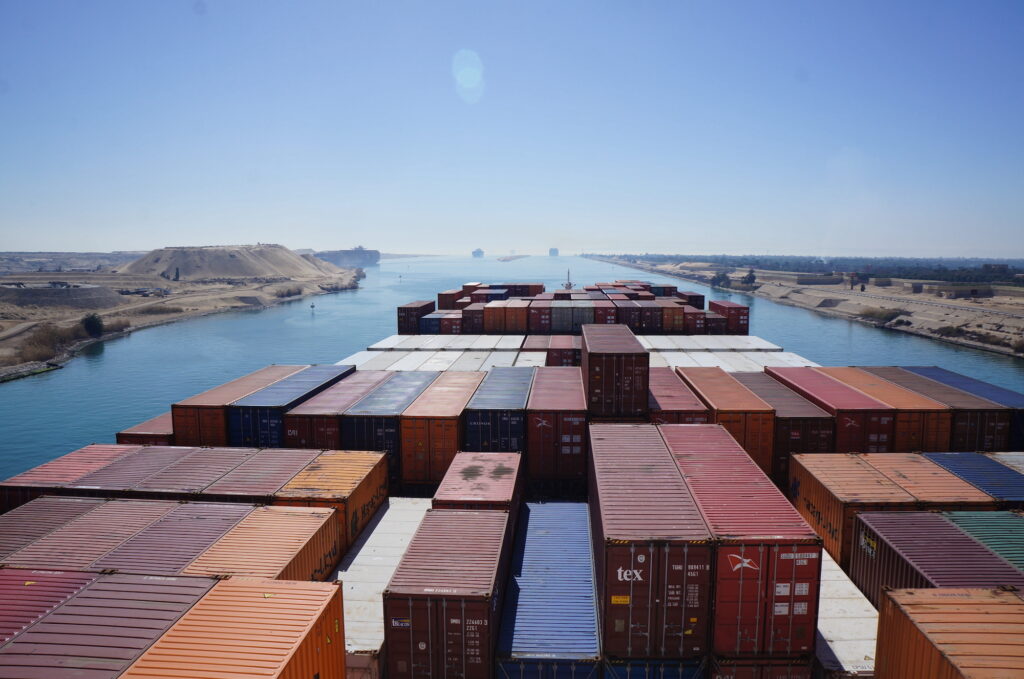 Image of containers on a ship passing through the Suez Canal.