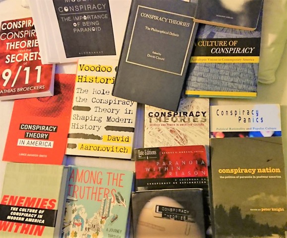 A spread of book covers about conspiracy theories